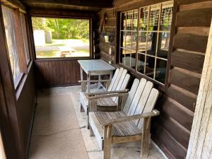 The first log cabin porch with lounge chairs (Number 3)